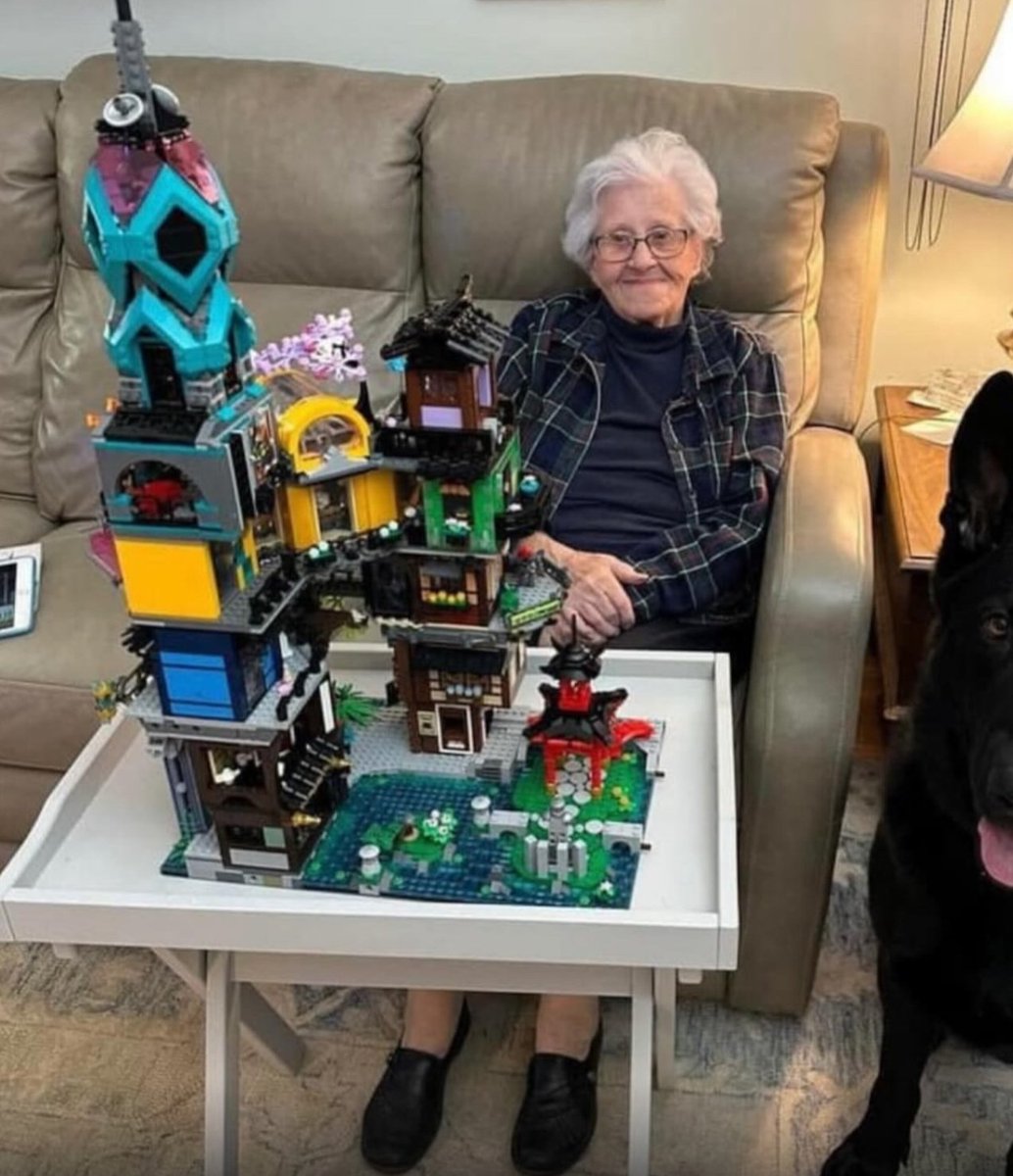 WolfofX's tweet photo. Mary didn't grow up with LEGO.

She discovered the hobby much later in life, long after most people would have assumed it was too late to start something new. What began as simple curiosity slowly turned into a weekly ritual. Even at 97 years old, she still spends around four to six hours building, one brick at a time, patiently bringing enormous LEGO creations to life.

Her collection includes some of the most demanding sets LEGO has ever produced. The LEGO Titanic alone contains 9,090 pieces and stretches more than 135 centimeters long. She has also completed the LEGO Colosseum, another masterpiece made from over 9,000 pieces, along with several other highly detailed display models.

Photographer Steven Farrel has documented her journey, often capturing her building in her cozy living room with her dog resting nearby. Those photos introduced millions of people to the woman now affectionately known as "LEGO Grandma."

There is no rush in the way she builds. No race to finish. Just steady hands, quiet focus, and the satisfaction of watching thousands of tiny pieces slowly become something extraordinary.

At an age when many people believe their best years of learning are behind them, Mary continues to prove that curiosity never grows old. Every completed model is a reminder that it's never too late to begin something new, and that passion doesn't measure time by birthdays.