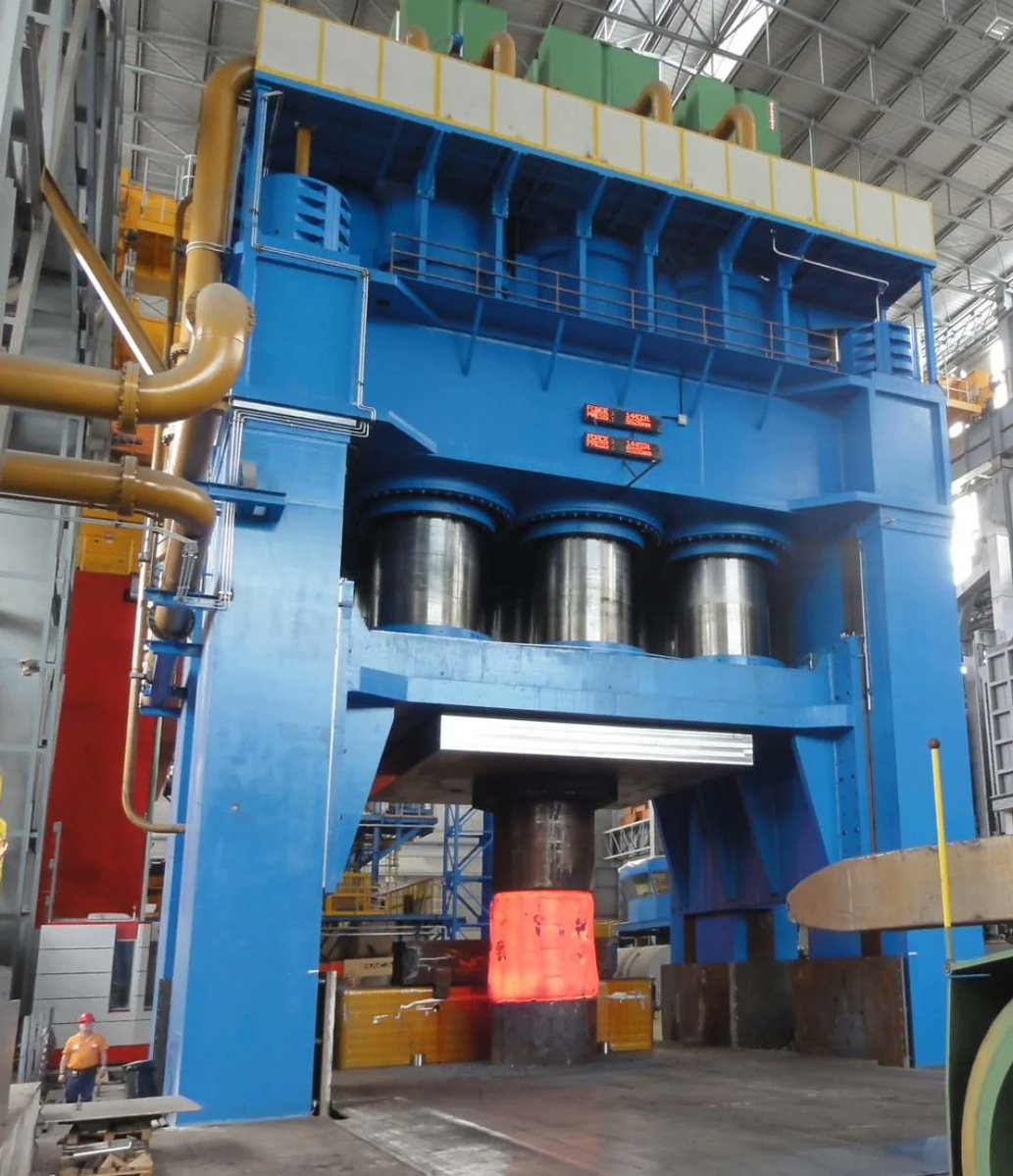 Arkasiraee's tweet photo. A giant forging press is one of the most powerful machines ever built by industry. These massive systems can exert 50,000-100,000 tonnes of force, using enormous hydraulic cylinders driven by highly pressurised oil. 

But the true engineering challenge is not generating this force it is controlling it with precision as one wrong actuation could destroy the press. 

Inside these machines are hydraulic systems operating at 250-700 bar pressure, where thousands of litres of oil are pushed through precision-engineered valves to move pistons weighing hundreds of tonnes. 

The hydraulic cylinders are built from ultra-high-strength alloy steels designed to survive repeated extreme loads, while servo valves with internal clearances of only a few micrometres regulate oil flow in milliseconds. 

Advanced sensors continuously monitor position with extreme precision, pressure, and force, allowing control systems to adjust the press thousands of times per second.

The scale is extraordinary, a single forging press can cost $100-500+ million, with complete facilities exceeding $1 billion. Building one requires expertise in massive steel manufacturing, precision machining, high-pressure hydraulics, and control engineering that only a handful of industrial nations possess.

A forging press may look like a machine built around brute force, but its real achievement is precision under unimaginable loads turning thousands of tonnes of hydraulic pressure into controlled deformation at the atomic level of metals. 

This capability creates the ultra-high-strength forgings that form the backbone of modern aviation, space exploration, nuclear energy, power generation, defence, and heavy industry, where material failure is not an option.