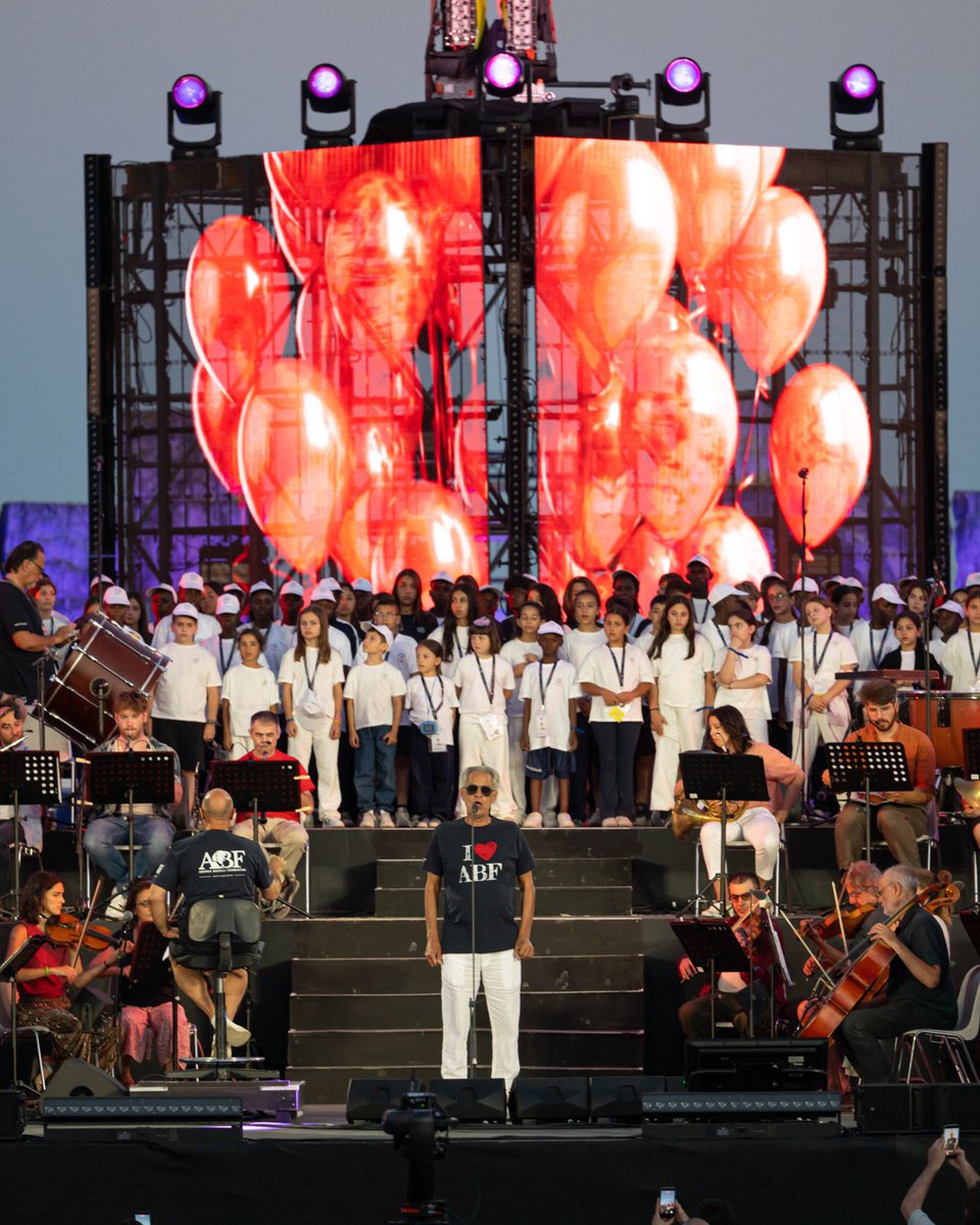 abfoundation's tweet photo. Yesterday, the young choristers of ABF Voices Of took the stage at the #TeatrodelSilenzio for the dress rehearsal of the concert in which they will perform today alongside founding conductor Andrea Bocelli.​

It was a deeply moving moment for the girls, boys, young people, and choir directors from Haiti, Uganda, the Holy Land, Camerino, and Rione Sanità, who are currently sharing in the experience of the first ABF Global Gathering. ​

Tonight’s performance marks an important milestone in a journey built over time through choral practice, the encounter between different cultures, and the personal growth experienced within the educational communities of ABF Voices Of.