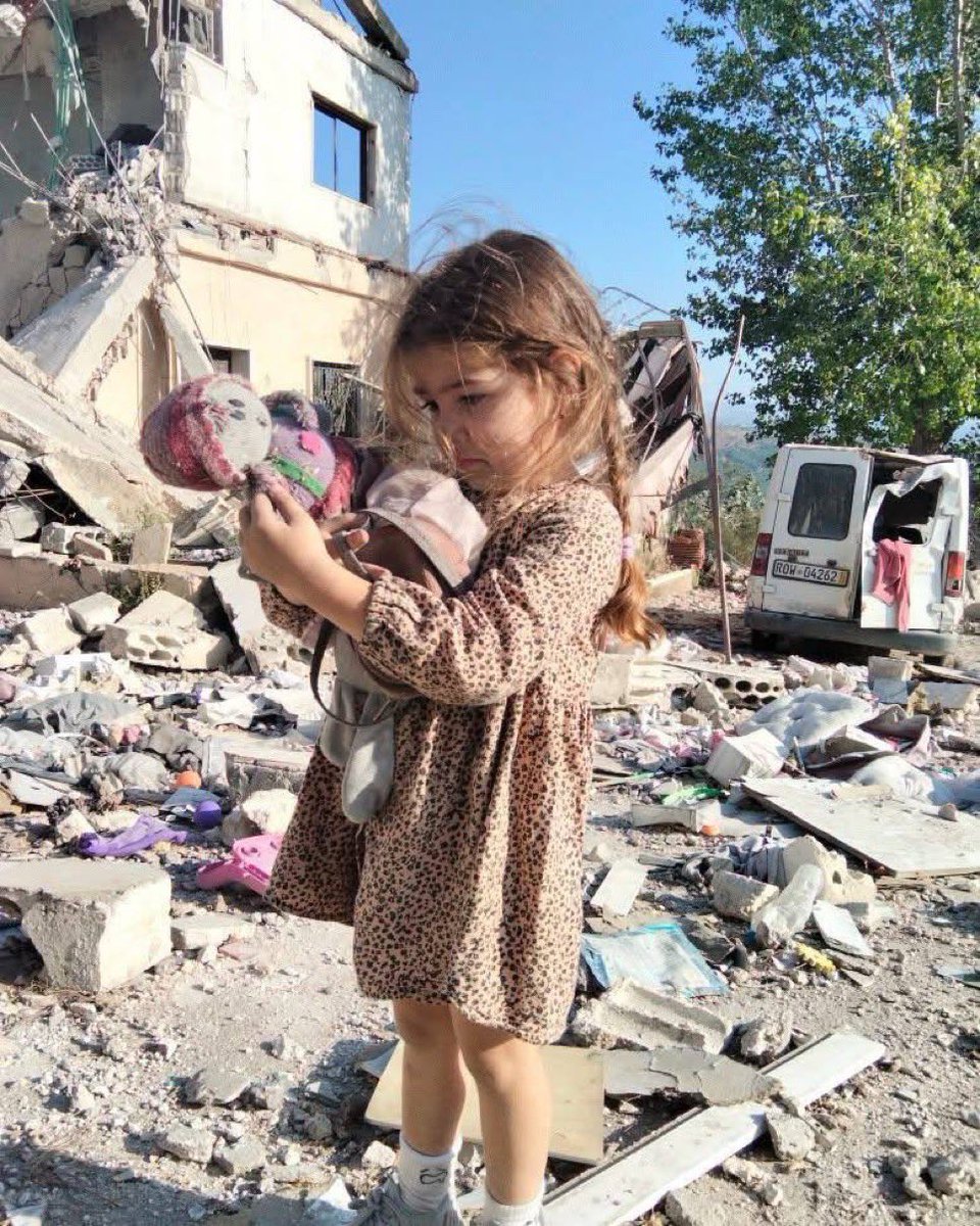 VintageVault8's tweet photo. israeli terror continues in Lebanon.. 

Little Ayleen is sad holding the toys she found in the rubble of her destroyed home in Zawtar, South Lebanon yesterday. Like hundreds of thousands of children, her childhood is being shaped by israeli terrorism https://t.co/yHKTOThW5p