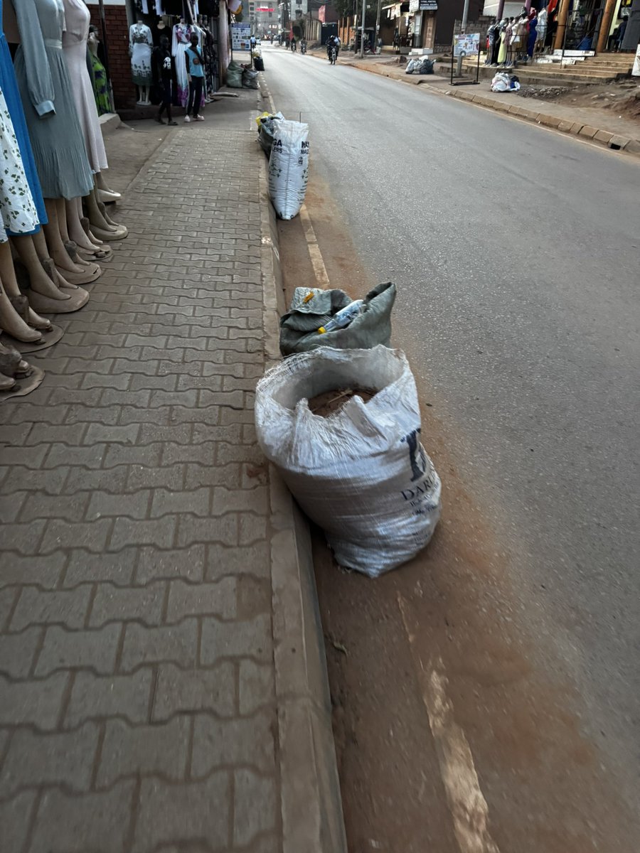 GodwinTOKO's tweet photo. It's 7 pm, hours since @PoliceUg took back their guns, & the @UgandaMediaCent turned off their cameras, yet the rubbish remains where it was left! Some of it blocking the walkway, & pausing a safety hazard for pedestrians! Should it rain in the night, boom!

See the problem of rushing a policy because you want to show power & get social media likes without thinking them through, @KCCAUG & @OPMUganda?!