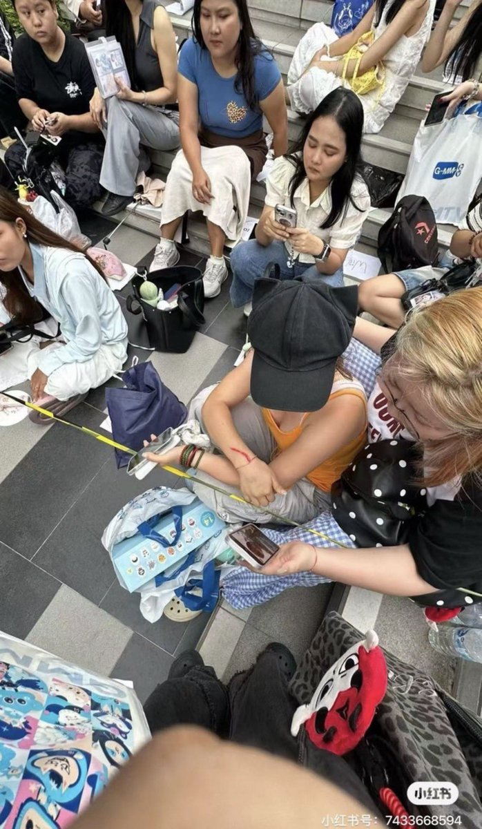 sugarformyfilm's tweet photo. as we know in Thailand during the gathering, fans place items to reserve their spots… 

 What actually happened is a Chinese woman swiped one of the spots (the paper) (pic for reference) with her umbrella!! 
Then security had to interfere and things escalated.​​​​​​​​​​​​​​​​​​​​​​​​​​​​​​​​​​​​​​​​​​​​​​​​​​

before.                        after https://t.co/e1eUAO6wQ0