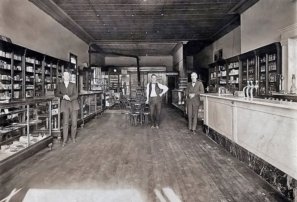 TracesofTexas's tweet photo. Traces of Texas reader Jana Hinkley graciously shared this super photo of the Kandy Kitchen in Alpine, which was a candy/soda fountain in Alpine for 40+ years. Jana told this great story:

"For more than forty years, The Kandy Kitchen served the sweet-tooth of the people of Alpine and the Big Bend country. “The place where the live ones like to linger,” was established in 1911 by Shirley Scales and was co-owned later with his brother Otis Scales, who continued to operate the Kandy Kitchen after Shirley retired. This professional business photo, probably from the late 1920s, shows the two Scales brothers with one of their college-age employees. [My grandfather Lee Matt Smith worked here while he was in college at Sul Ross and, while this photo is from his collection, I’m not convinced that the employee in the middle is my grandfather.]

The Kandy Kitchen made most of the candies which were sold at the establishment but carried such brands as Whitmans, Saylor, Pangburns, Hoffmans and other well-known candies. The Kandy Kitchen also served their own homemade ice cream, a delight to ice cream lovers. They offered curb service and maintained a well equipped fountain with ample seating space to take care of large groups of college students at one time.

The Kandy Kitchen building, located “across from the Southern Pacific Depot” (as advertised in the El Paso Times), was built by William Daugherty, a building contractor, custom woodworker and cabinet maker. Daugherty built many of the early homes in Alpine as well as the First Christian Church and the Mitchell-Gillett building. He also drew the plans and supervised the construction of the original Masonic Temple in Alpine.

In the late 1950s Otis Scales sold the business to Jimmie Logan, who operated it for a few years, and then the Kandy Kitchen was closed out with a big auction sale which attracted much attention in Alpine for a number of days.

Note from Traces: I believe this building still stands on the southwest corner of 5th and Murphy in Alpine.

Thank you, Jana. This is a fantastic family artifact.