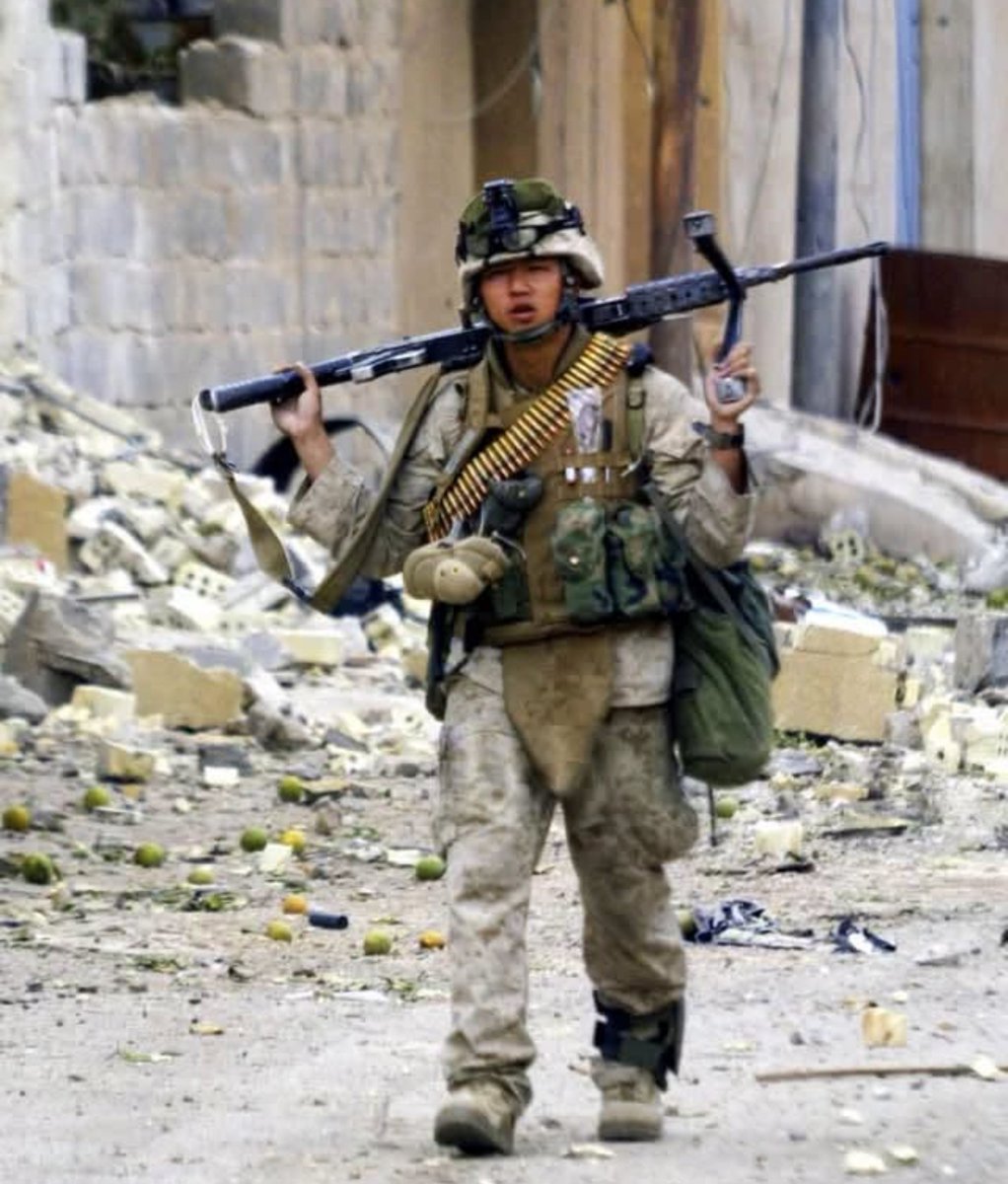 specialopsmag's tweet photo. US Marine from Kilo Company, 3rd Battalion, 5th Marines, stands in Fallujah, Iraq, on November 17, 2004, squarely in the thick of Operation Phantom Fury, the Second Battle of Fallujah. 

The Darkhorse Battalion, 3/5, bore some of the heaviest fighting of the entire operation. By mid-November the battle had already stretched through nearly two weeks of the fiercest urban combat American troops had seen since Hue City in Vietnam. Kilo Company emerged as one of the most heavily decorated and hardest hit units of the fight. 

Marines methodically cleared house after house in a city the insurgents had spent months transforming into a maze of fortified positions, booby trapped entrances, and interlocking kill zones. The images that came out of those days remain among the war’s most searing: exhausted Marines framed in doorways, streets choked with rubble and spent casings, men who had been awake and under fire for days on end.

The toll on 3/5 was severe. Kilo Company alone suffered a heavy share of the battalion’s dead and wounded, casualty rates that matched some of the bloodiest weeks of Vietnam compressed into a short, brutal span. That is why Fallujah occupies such a central place in Marine Corps memory of the war, not a single spectacular raid, but a relentless, room by room grind that demanded extraordinary resolve from ordinary infantrymen, day after day, until the city was finally secured. 

One photograph from the heart of that struggle still stands as a quiet testament to exactly what those days required of the men who endured them.