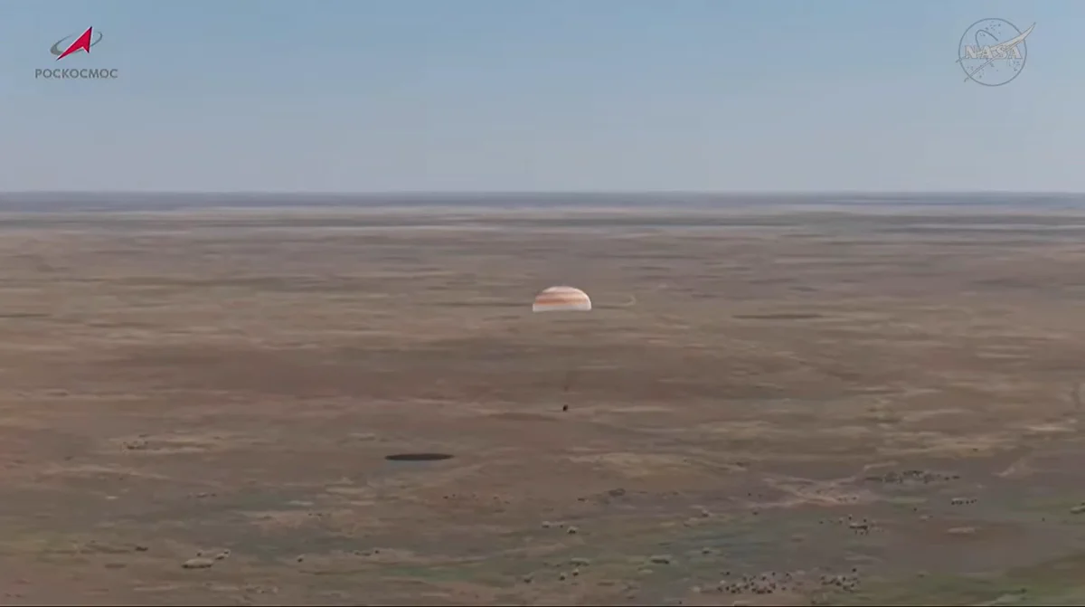 The Soyuz MS-28 spacecraft is seen as it lands in a remote area near the town of Zhezkazgan, Kazakhstan with NASA astronaut Chris Williams and Roscosmos cosmonauts Sergey Kud Sverchkov and Sergei Mikaev.