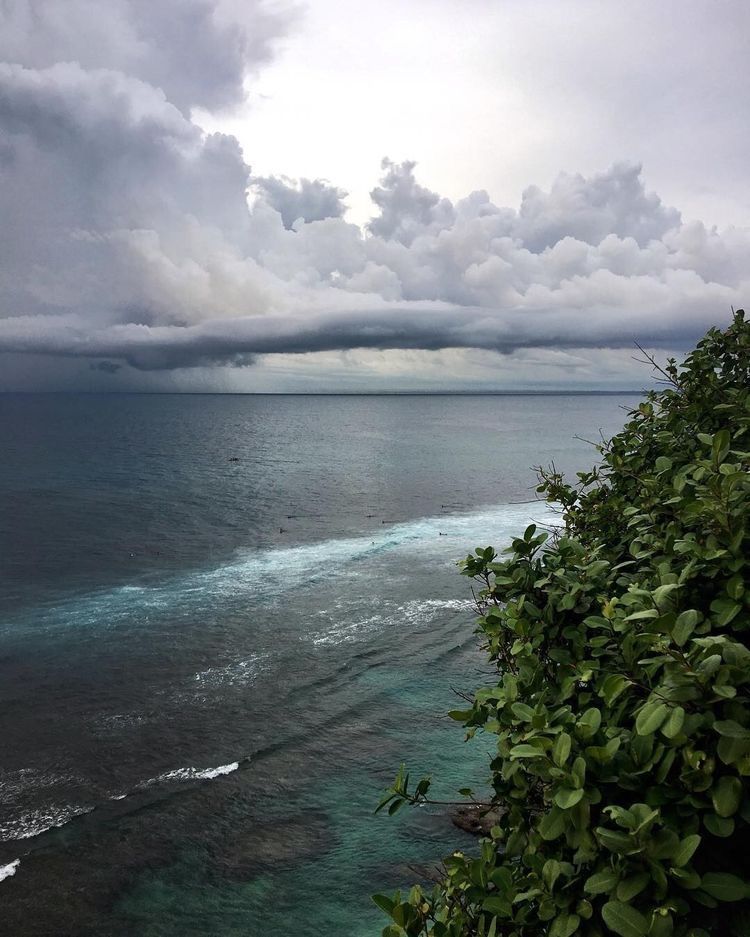 greenvibe's tweet photo. The sea stays quiet while the sky gathers its storm. https://t.co/0Zf9CA9iWr