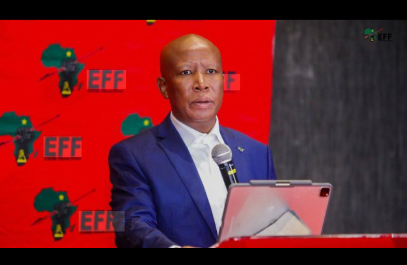 Mzansiawake's tweet photo. South Africa has over 700 political parties.  
700 manifestos.  
700 slogans.  
700 promises.

But only one party says the things that hurt.  
Only one party names the pain that people whisper about in taxis.

EFF.

EFF talks about the child who writes exams by candlelight.  
EFF talks about the graduate with 3 degrees and no job.  
EFF talks about the land your grandfather lost.  
EFF talks about the clinic with no medicine.  
EFF talks about the mine worker who dies and the CEO who gets a bonus.

The other 699 parties talk about themselves.

They talk in boardrooms.  
EFF talks in the streets.  
They talk in English.  
EFF talks in your language.  
They talk every 5 years.  
EFF is there when there’s no camera.

You can hate the noise.  
You can hate the red berets.  
You can hate the disruption.

But you cannot say EFF is silent when people are bleeding.

Out of 700, only one keeps reminding this country:  
"Poverty is not normal. Unemployment is not normal. Inequality is not normal."

That is why they attack EFF the most.  
Because pain, when spoken out loud, becomes power.@Mzanziawake
