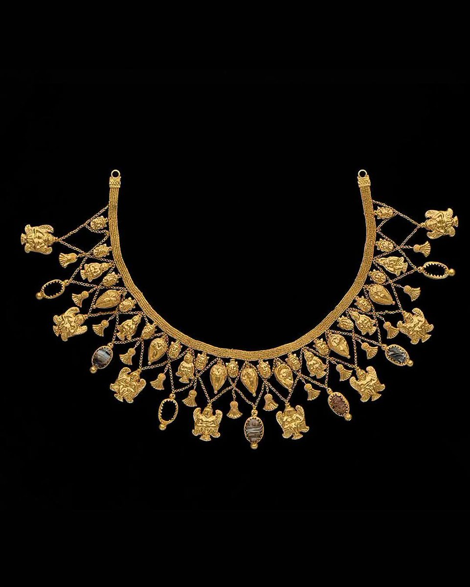 histories_arch's tweet photo. A 5th Century BC, Etruscan necklace features four rows of intricate pendants depicting bearded heads, seated human-birds, acorns, inverted lotus flowers, and onyx scarabs.

Each of these elements carries profound meaning. The bearded heads expressed strength and wisdom, serving as protective guardians for the afterlife. The seated, watchful posture of the winged humans created a symbolic barrier between the living and the dead. Acorns represented a hope for rebirth and family continuity, while the lotus, inherited from Egypt as a symbol of birth and the sun, was stylised in an inverted form to symbolise the soul's descent into the underworld. Finally, the onyx scarabs, another symbol borrowed from Egypt that was immensely popular in Etruria, embodying eternal renewal and transformation.

Since every symbol on this piece is tied directly to death and rebirth, it is highly probable that this sumptuous, incredibly expensive necklace was never worn by a living woman, but was crafted exclusively to adorn her body during her funeral and in her grave.  

© The Trustees of the British Museum

#archaeohistories