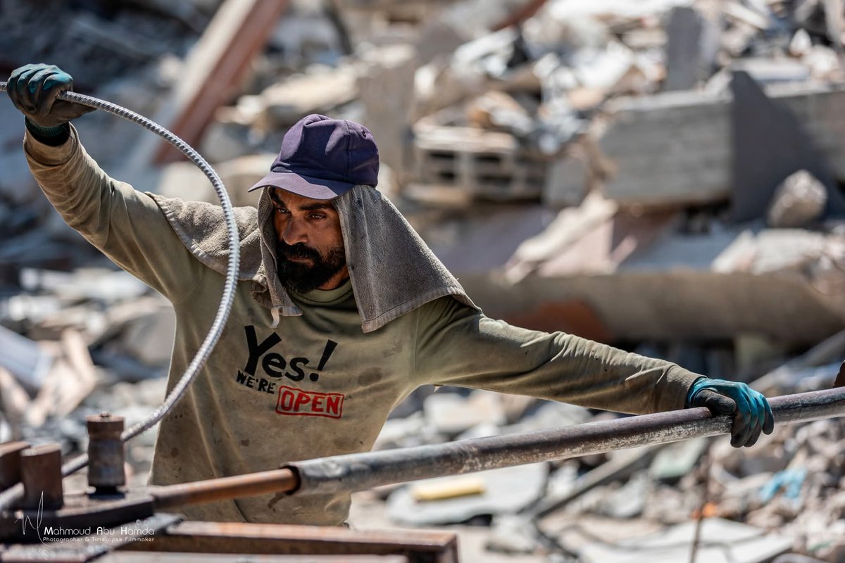 PalPress24's tweet photo. Residents of Gaza are carrying out grueling manual labor to extract steel rebar from the rubble using only simple tools, so it can be repurposed into the frames of tents that provide shelter for displaced families. https://t.co/2UBT2gxTps