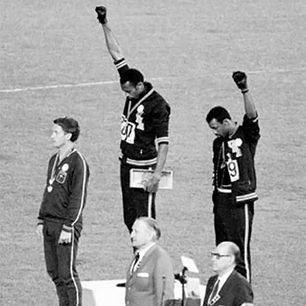 Timeless_Vis's tweet photo. During the 1968 Mexico City Olympics, American sprinters Tommie Smith and John Carlos raised black-gloved fists on the podium during the national anthem. https://t.co/grTRNmowL5