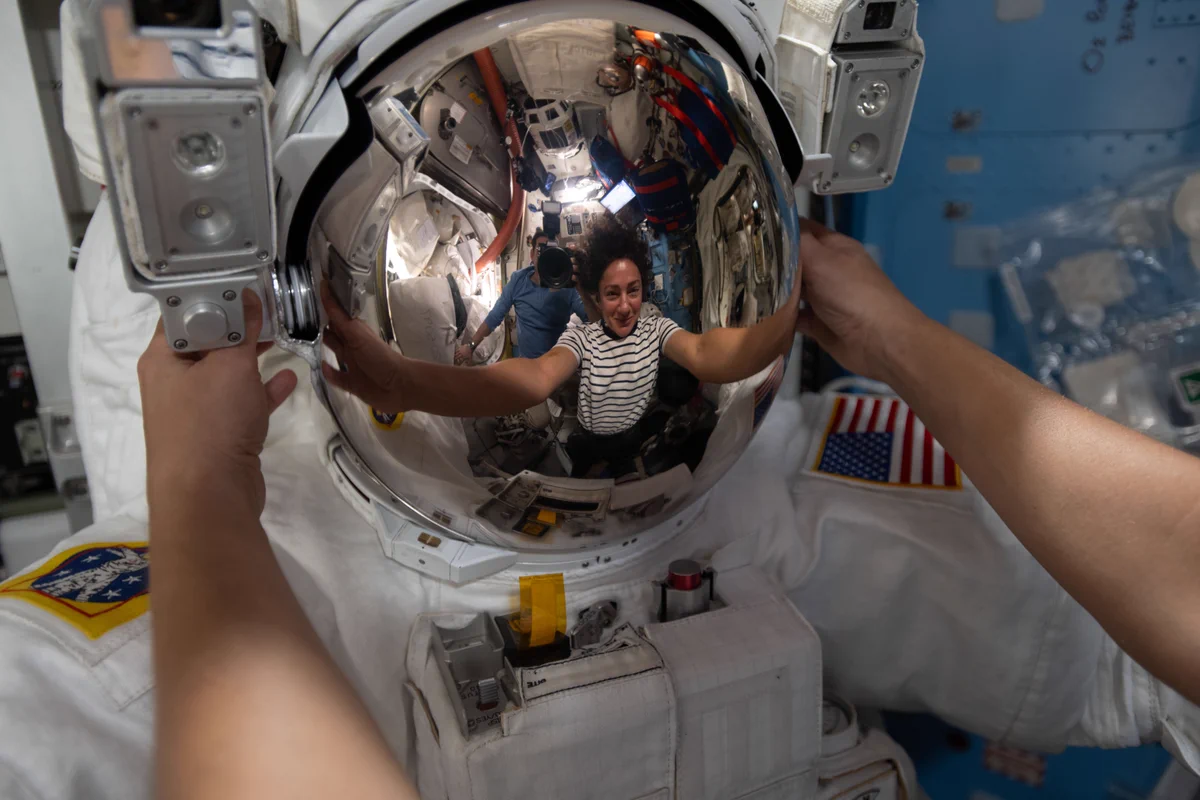 NASA astronaut Jessica Meir works inside the International Space Station’s Quest airlock in March, her reflection visible in a spacesuit helmet visor as she installs leg and arm components and swaps parts between suits.
Credit: NASA/Jack Hathaway