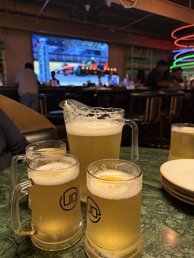 HydREGuide's tweet photo. A client of mine invited me to watch the Hungarian Grand Prix at Underdoggs Sport bar in Sattva Knowledge Park in HITEC City.  Though I don't really follow F1 or motorsports, I wanted to check out the vibe.

We reached around 7 PM, and the place was already packed. The atmosphere was excellent, with everyone completely into the race.

We ordered Geist Witty Wit, brewed with orange zest and coriander. I had tried it before at another place, but somehow it tasted much better here. For food, we went with our regular favorites: the Tandoori Platter, Chicken 65, and Bhatti Murg. The food was pretty good. A couple of pieces in the Tandoori Platter weren't as warm as I expected, but apart from that, I really enjoyed everything.

If you enjoy watching sports with a crowd, I'd definitely recommend giving this place a try. I'm sure you will like the experience.