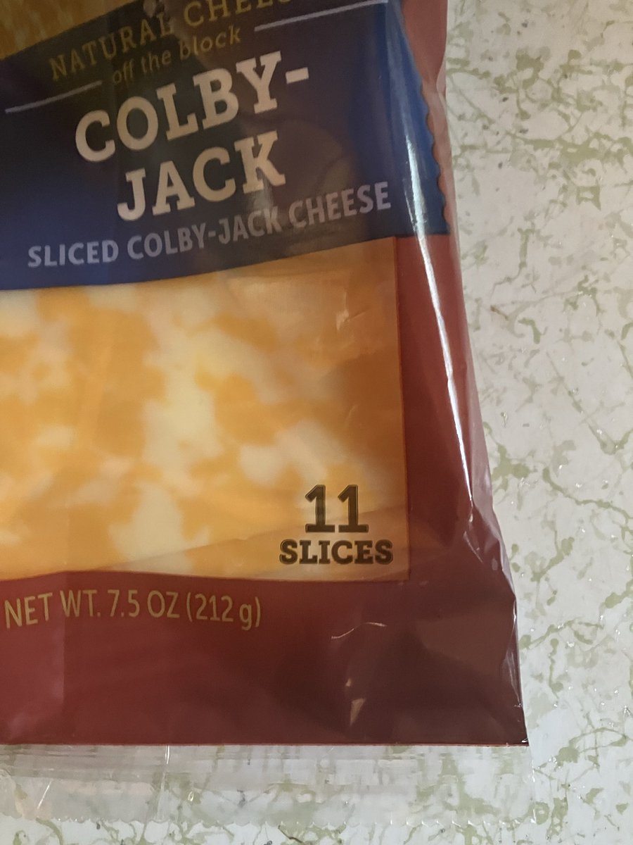 TonyHursh's tweet photo. I was curious what process led to the choice of 11 slices rather then 10 or 12.

I think I've figured it out. This is a 7.5 ounce package, which is also a rather peculiar amount. Buuuut.... if you calculate the weight per slice you'll notice that 12 slices would work out to just a hair over 8 ounces.

Theory: the cheese used to come in a 12 slices, 8 ounce package.

At some point they started packaging one less slice while continuing to charge the same price.

This is called "shrinkflation".

Does anyone happen to remember if 8 oz/12 slice was the previous norm?