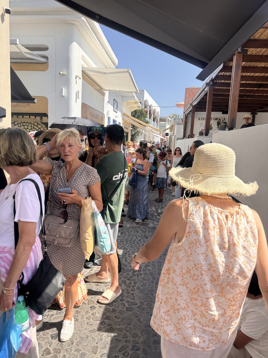 MaryEmeryWells's tweet photo. Santorini is beautiful, but a 4+ hour cable car line after a rockfall was unacceptable. Seeing elderly visitors, people with disabilities, and young children stranded in the heat was heartbreaking. If cruises keep coming, there needs to be a better plan. #Santorini #Cruise https://t.co/c89tQIxhg0