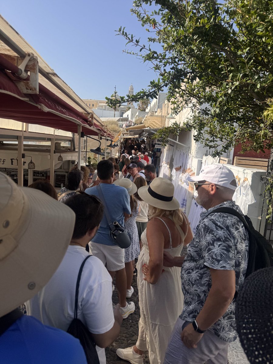 MaryEmeryWells's tweet photo. Santorini is beautiful, but a 4+ hour cable car line after a rockfall was unacceptable. Seeing elderly visitors, people with disabilities, and young children stranded in the heat was heartbreaking. If cruises keep coming, there needs to be a better plan. #Santorini #Cruise https://t.co/c89tQIxhg0