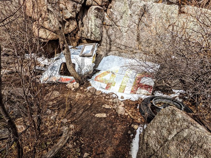 MCCCANM's tweet photo. The Sandia Peak Tramway in Albuquerque used to point out to visitors where TWA 260 crashed into the Sandia Mountains in 1955. It remains the deadliest crash in NM, killing 16.

They left the wreckage, as it was too much to haul down. When the tree canopy is not thick, it’s visible under the Tram.

You can also hike to the site. Anyway, apparently some family found it offensive recently. I suppose I can see that argument. They now don’t point out the crash site (I asked the operator).

Initially, the crash was blamed on intentionally flying into the mountain, implying the pilots had a suicide pact. This was outrageous, and the board was forced to remove the term “intentional”, but blamed it on pilot error. The winter weather was bad at the time. Eventually, the board had to concede that a known fault in how the compass works could have led to the crash as the pilots were in clouds at the time, so the official report is that the plane flew into the mountain for reasons unknown. It’s an early example of pilot unions pushing back on crash investigations, and a quite reasonable one at that. Nobody takes off thinking they will die.

My dad hiked up there maybe 15 years ago. He was around 70 at the time. It’s illegal to remove any wreckage, as it’s now legally a historic site. You can still see the TWA markings on much of the debris.

A small memorial in a picture frame was placed on the wreckage, listing the victims & explaining the accident. I will include a picture of that, as it seems more respectful.