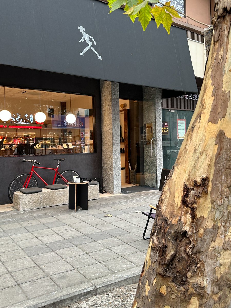 Lancelogan12's tweet photo. Coffee in one hand, city vibes in the other. Late-afternoon street light hitting the old storefront – perfect random Tuesday energy. https://t.co/T8SweGhKSr