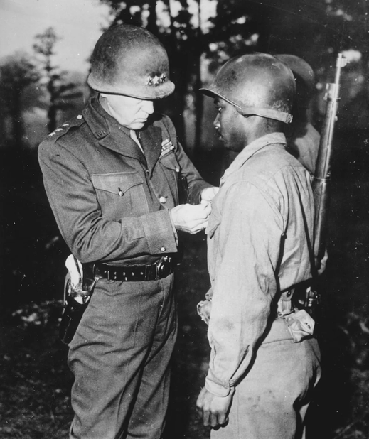 Jimfrombaseball's tweet photo. "Men, you're first Negro tankers to ever fight in the American Army.
I would never have asked for you if you weren't good.
I have nothing but the best in my Army.
I don't care what color you are as long as kill those Kraut sons of bitches.
Everyone has their eyes on you and are expecting great things from you.
Most of all, your race is looking forward to your success.
Don’t let  them down, and, damn you, don’t let me down!
There’s one great thing that you men can say when it’s all over and you’re at home once more.
You can thank God that twenty years from now when you’re sitting by the fireside with your grandson on your knee, and he asks you when you did in the war, you won’t have to shift him  to the other knee, cough and say:
I shovelled horse shit in Louisiana.
If you want me, you can always fine me in the lead tank."
Lieutenant General George Patton.
Patton pins a, "Silver Star' Medal on Private Ernest Jenkins, a member of the 761st Tank Battalion, "The "Black Panthers", honored for bravery, 1944, at "The Bulge."