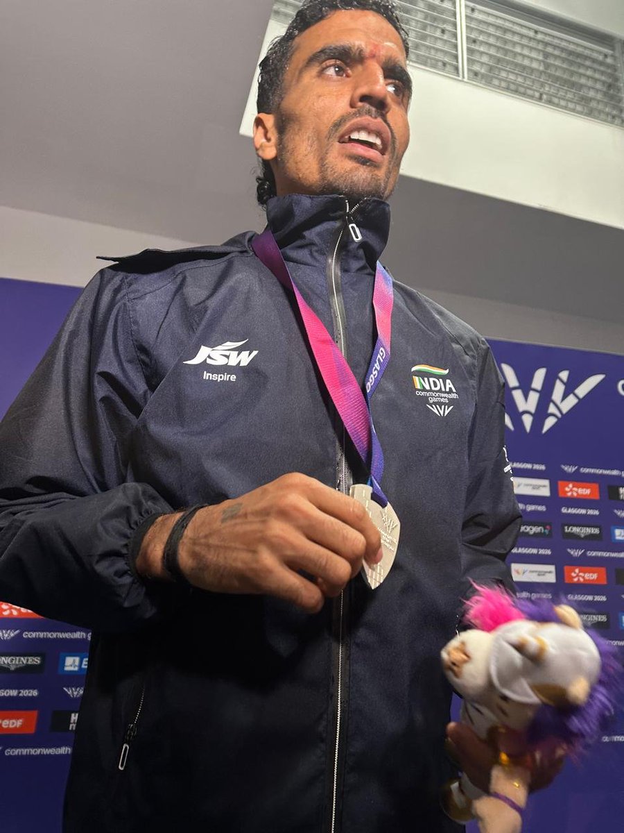 MisraSundeep's tweet photo. The Rain, The Dice, The Glory

It was a night like no other. Ky Robinson became the first Australian to win the Commonwealth Games 10,000m. Gulveer Singh gave India ITS FIRST EVER CWG 10,000M SILVER. And Mullarkey captured the Isle of Man’s first-ever bronze in the event. On a storm-soaked track, three men ran past an entire continent and stepped into uncharted territory.

Streaking through the puddles, track awash in Glasgow rain, the reign of the Kenyans and the Ugandans was shattered by a motley bunch: an Australian, an Indian, and an Isle of Man athlete. Ky Robinson clinched gold with a dizzying sprint in 27:48.93. Gulveer Singh, boxed in a bit down the stretch, made room on the right, saw air, and sprinted for it. He crossed the line as if in a stupor, half-expecting to see the Africans up front, his time matching the clock at a breathtaking 27:48.93. In a similarly joyous run, David Mullarkey took bronze for the Isle of Man in 27:50.28.

​For decades, the Africans had conquered the long distances. They lived in the relentless monotony of the laps. They intimidated the rest, suffocating them kilometre by kilometre until the opposition had nothing left. By the final lap, the final 200 meters, their ferocious kick squeezed out whatever air was left in the field.

​Not on this night. Under dark skies, the driving rain brought a new dawn -especially for Indian long-distance running.

​Gulveer hunted. He remained nestled in the pack, oscillating between second and sixth, mostly hanging tough in fourth. Ky swung between fourth and seventh, biding his time until the 7k mark hit, where he boldly seized the lead. Gulveer slipped back to ninth for a moment, and it seemed the dice weren’t rolling his way. But he woke up, snatched the dice back, and as they passed the 9k mark, carved his way into third.

​On the final turn, the track became a battlefield. Legs heavy, lungs burning, they threw everything into the wet track. Gulveer, seeing Ky sprinting away, saw history, legend status, and national glory all staring back at him, coated in brilliant silver, and made his definitive surge. Behind him, Mullarkey, who had once languished in tenth, quietly clawed his way up the field. With a hundred meters to go, realizing he was sitting in third, his eyes shone bright with the shock of what was about to happen. He unleashed a desperate, glorious sprint to lock down his place in history.
#Gulveer #GulveerSingh
#CWG2026
#Glasgow2026
#Indianathletics
#Historymade #glasgowmeintiranga