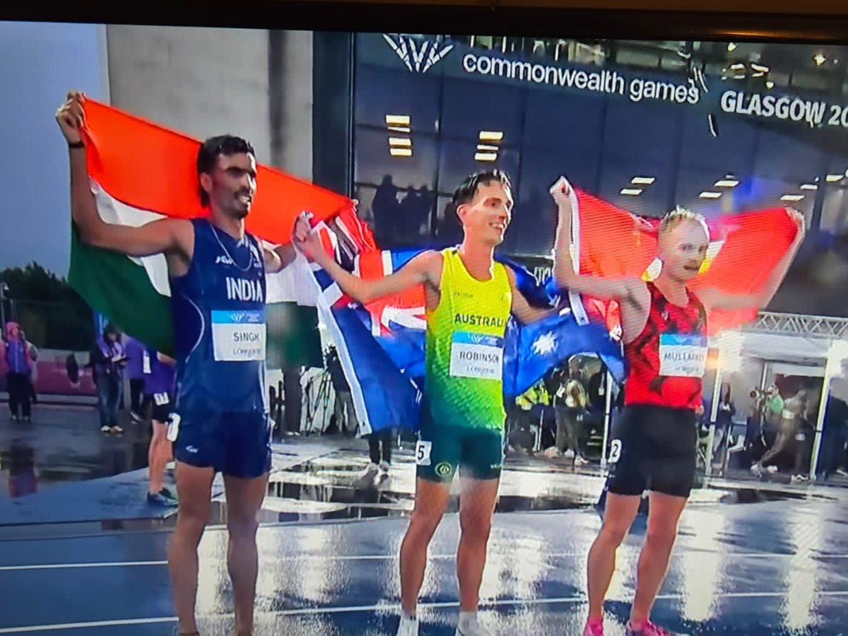MisraSundeep's tweet photo. The Rain, The Dice, The Glory

It was a night like no other. Ky Robinson became the first Australian to win the Commonwealth Games 10,000m. Gulveer Singh gave India ITS FIRST EVER CWG 10,000M SILVER. And Mullarkey captured the Isle of Man’s first-ever bronze in the event. On a storm-soaked track, three men ran past an entire continent and stepped into uncharted territory.

Streaking through the puddles, track awash in Glasgow rain, the reign of the Kenyans and the Ugandans was shattered by a motley bunch: an Australian, an Indian, and an Isle of Man athlete. Ky Robinson clinched gold with a dizzying sprint in 27:48.93. Gulveer Singh, boxed in a bit down the stretch, made room on the right, saw air, and sprinted for it. He crossed the line as if in a stupor, half-expecting to see the Africans up front, his time matching the clock at a breathtaking 27:48.93. In a similarly joyous run, David Mullarkey took bronze for the Isle of Man in 27:50.28.

​For decades, the Africans had conquered the long distances. They lived in the relentless monotony of the laps. They intimidated the rest, suffocating them kilometre by kilometre until the opposition had nothing left. By the final lap, the final 200 meters, their ferocious kick squeezed out whatever air was left in the field.

​Not on this night. Under dark skies, the driving rain brought a new dawn -especially for Indian long-distance running.

​Gulveer hunted. He remained nestled in the pack, oscillating between second and sixth, mostly hanging tough in fourth. Ky swung between fourth and seventh, biding his time until the 7k mark hit, where he boldly seized the lead. Gulveer slipped back to ninth for a moment, and it seemed the dice weren’t rolling his way. But he woke up, snatched the dice back, and as they passed the 9k mark, carved his way into third.

​On the final turn, the track became a battlefield. Legs heavy, lungs burning, they threw everything into the wet track. Gulveer, seeing Ky sprinting away, saw history, legend status, and national glory all staring back at him, coated in brilliant silver, and made his definitive surge. Behind him, Mullarkey, who had once languished in tenth, quietly clawed his way up the field. With a hundred meters to go, realizing he was sitting in third, his eyes shone bright with the shock of what was about to happen. He unleashed a desperate, glorious sprint to lock down his place in history.
#Gulveer #GulveerSingh
#CWG2026
#Glasgow2026
#Indianathletics
#Historymade #glasgowmeintiranga