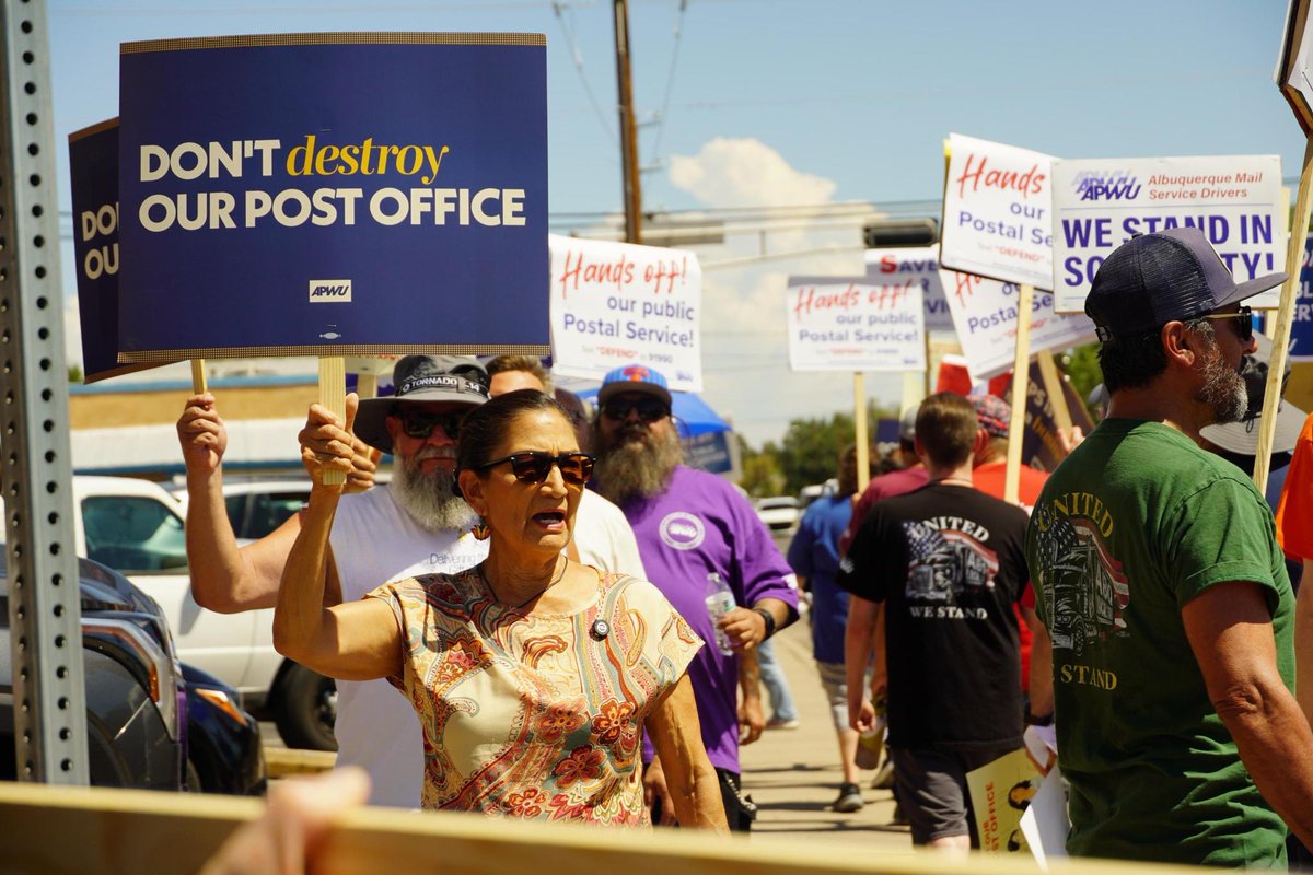 DebHaalandNM's tweet photo. The Postal Service is a lifeline for New Mexico. It connects rural communities, delivers lifesaving medications, supports small businesses, and ensures every family can stay connected no matter where they live.

That's why I was proud to stand with postal workers today. They deserve leaders who will protect good union jobs and defend the public services New Mexicans rely on, not politicians or billionaires who want to weaken or privatize them.