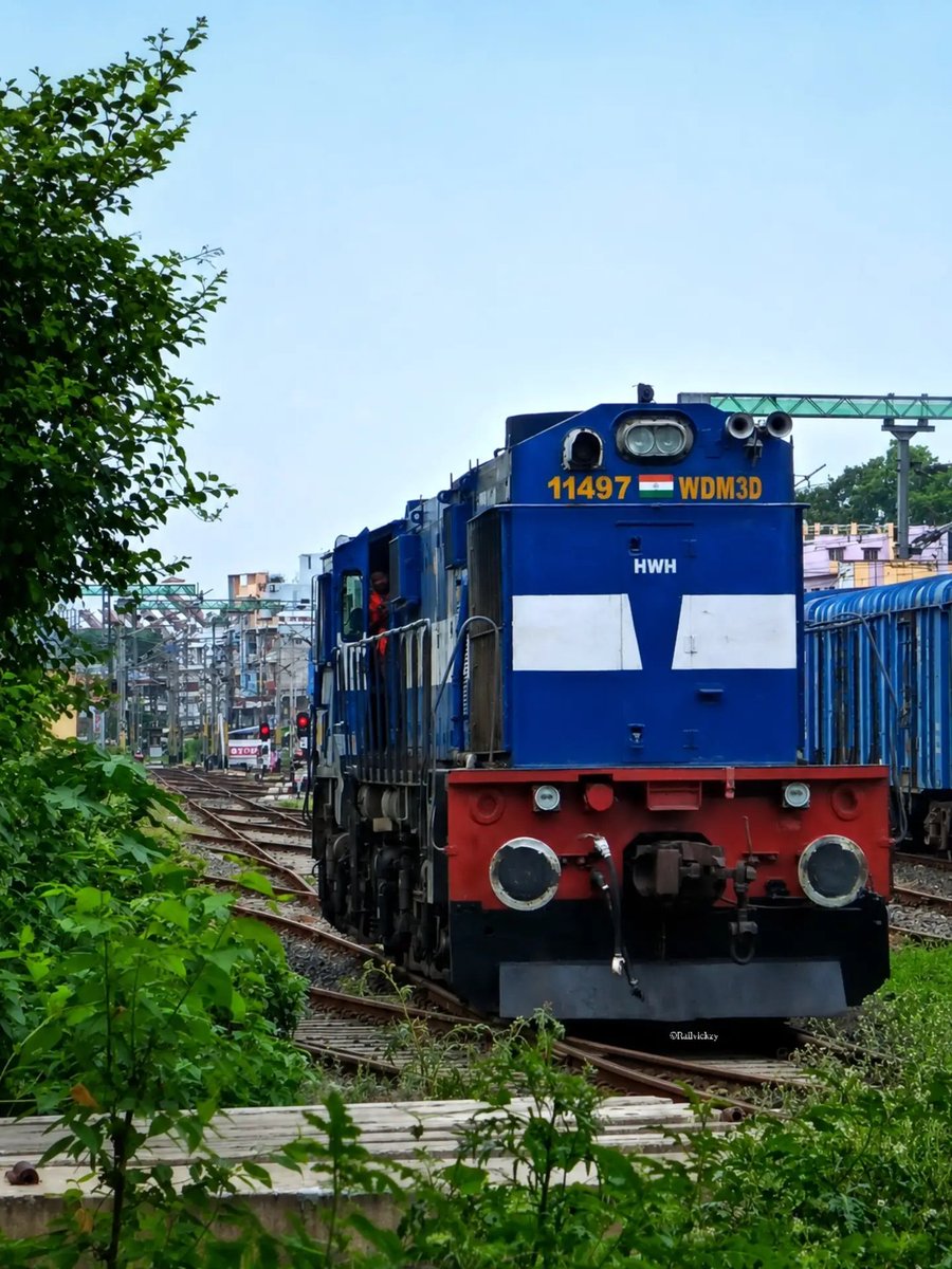 railvickzy's tweet photo. Spotted the mighty 11497 WDM-3D ALCO beast resting at the unelectrified goods yard of Ranaghat Junction! Proudly under Howrah Shed, this 3300 HP blue-white titan continues to rule with its legendary roaring chugs and smoke. Pure diesel nostalgia! #WDM3D #ALCO #IndianRailways https://t.co/WsBrJ4jaEr