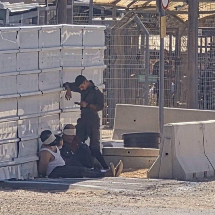 EyeonPalestine's tweet photo. The Lawyer Khaled Mahajneh wrote in a post:

“Outside the Salem Military Court, three blindfolded Palestinian detainees, their hands bound behind their backs, are forced to sit on the ground under the scorching sun while a soldier stands over them.

This image encapsulates just one part of the ordeal of oppression and abuse that Palestinian detainees endure from the very moment of their arrest.”

كتب المحامي خالد محاجنة في تغريدة : 

أمام المحكمة العسكرية في سالم ثلاثة معتقلين فلسطينيين معصوبو الأعين، مقيدو الأيدي إلى الخلف، يُجبرون على الجلوس على الأرض تحت لهيب الشمس، بينما يقف جندي فوق رؤوسهم.

صورة تختزل جانبا من رحلة القهر والتنكيل التي يواجهها المعتقل الفلسطيني منذ لحظة اعتقاله.