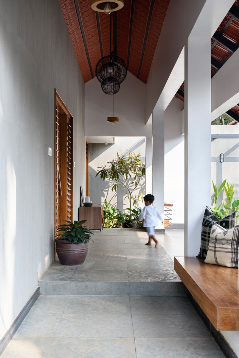 shavnyuyngah's tweet photo. “Terracotta roof tiles pulled indoors and pressed into a patterned ceiling.” That’s the first thing you notice at Sajeevan Residence, before the double-height spaces or the teak tones even register.

Studio Acis let the roofline carry the home’s traditional palette upward, ochre-red panels running the length of the pitched ceiling, echoing the same terracotta used outside. Paired with kota stone floors and teak, the roof stops being a boundary and becomes the room’s warmest surface.

Most homes hide the roof structure behind flat plaster. This one turned it into the interior’s main character.

Sajeevan Residence | Studio Acis
Kannur, Kerala, India | 2021 | Photographs: Justin Sebastian