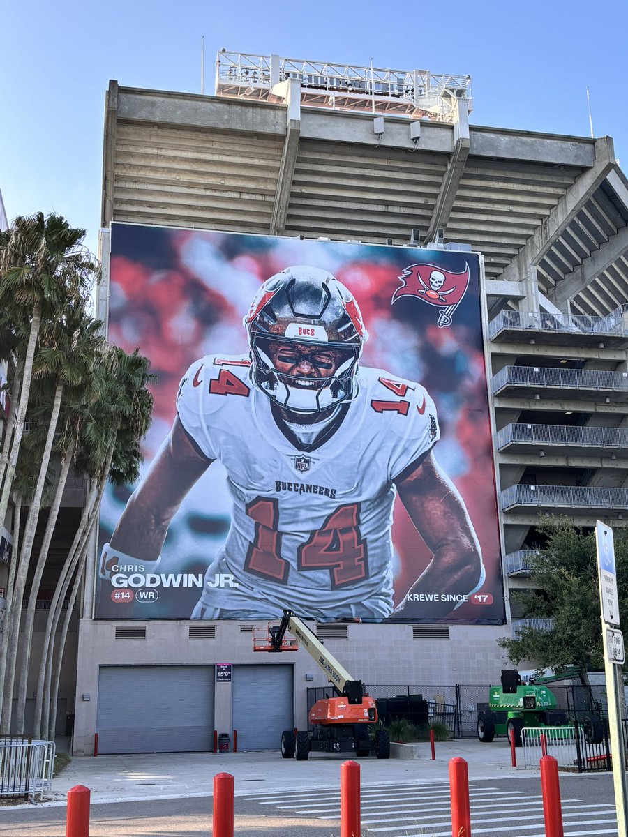 gregauman's tweet photo. Training camp begins for Bucs today, which means new player murals going up at Raymond James Stadium, with Chris Godwin first on the northwest corner.  @BaileyJAdams22 saw it first! https://t.co/Y6eYtGmyNm