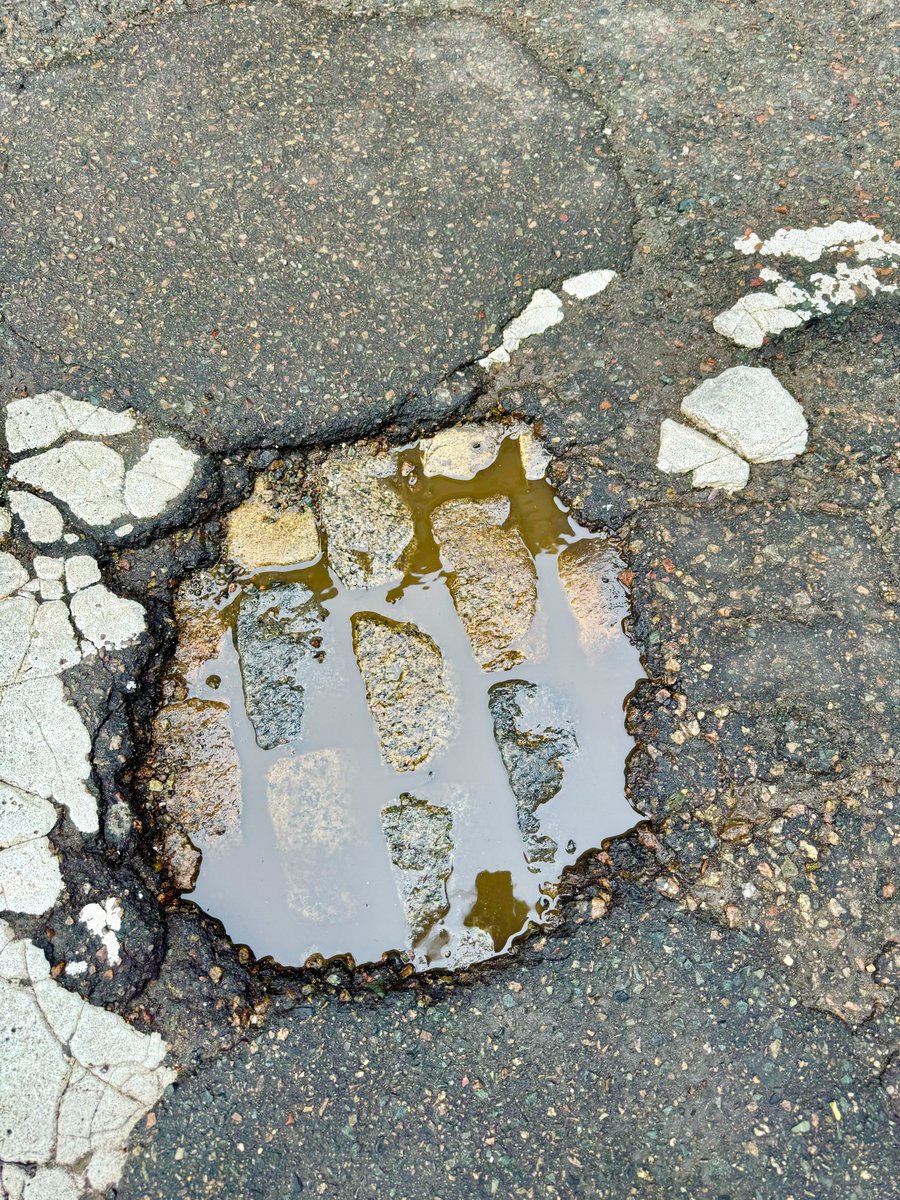 OnlyInBOS's tweet photo. The potholes are so big in Boston right now that you can see that our streets once used to be all cobblestone... https://t.co/JS6Y8sni3V
