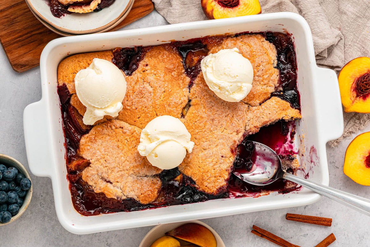 DishntheKitchen's tweet photo. Soft jammy peaches and tart blueberries with a buttery biscuit topping makes this Peach Blueberry Cobbler the ideal summer dessert. #nationalpeachmonth https://t.co/0KRg0ncFAA https://t.co/2pq0wSDziA