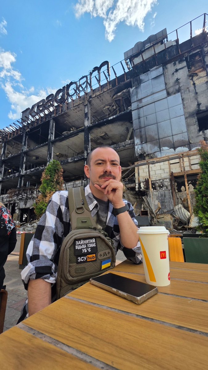 Xenta777's tweet photo. My son sent me these photos from Kyiv before returning to his military unit
This is the Lukianivka McDonald's, damaged by russian missile attacks many times but repaired every time
Behind him is the burned-out Kvadrat mall, destroyed in a russian missile attack on May 24, 2026 https://t.co/brcqxvUnx7