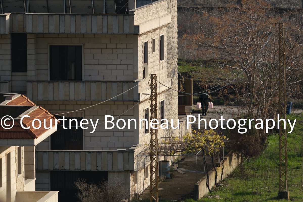 cbonneauimages's tweet photo. Here are photos I took in February of 2025 of Israeli soldiers walking house to house in the town of Yaroun, Lebanon. They were rigging homes with C4 explosives for multiple days in a row; taking the day to rig them and then detonating them in the evening. They flattened several neighborhoods during the period of time. 

In the photos you can see IDF soldiers wiring the homes and carrying C4. You can also see a truck transporting a large amount of the explosives.

This was not self defense. Each detonation is an act of genocide.