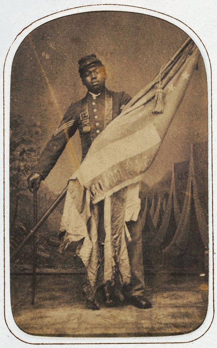 EchoesofWarYT's tweet photo. He carried the American flag up the wall at Fort Wagner, got shot to pieces doing it, and refused to let it touch the ground. His name was William Carney, and he was born into slavery.

Carney was born enslaved in Virginia around 1840. By some accounts he reached freedom through the Underground Railroad. When the Union finally let Black men enlist, he joined the 54th Massachusetts, the regiment we talked about at Fort Wagner.

On July 18, 1863, in that doomed dusk assault on the fort, the color sergeant carrying the national flag was cut down. Carney threw away his rifle, grabbed the falling colors before they hit the sand, and pushed forward to the parapet under a storm of fire, planting the flag on the wall of the fort itself. He was one of the farthest men forward in the entire attack.

When the assault collapsed and the survivors fell back, Carney would not leave the flag. He wrapped it around the staff and crawled and staggered back across that killing ground, shot in the head, the chest, the arm, and the leg. When he finally reached his own lines and collapsed, the men cheered him, and he said the line that outlived him: boys, I did but my duty, the dear old flag never touched the ground.

Carney survived. He lived until 1908 and worked for years as a mail carrier in New Bedford. His action at Fort Wagner is recognized as the earliest for which a Black American earned the Medal of Honor, though because the award came decades later, in 1900, he was not the first to actually receive one. Either way, the meaning is the same. A man born as property carried the flag of the country that had enslaved him, refused to let it fall, and bled to keep that promise off the ground.
