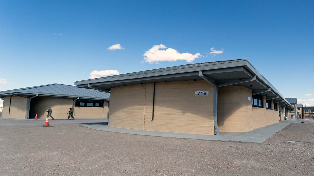 Osint613's tweet photo. A fleet of robotic 3D printers has completed the first of ten U.S. Army barracks at Fort Bliss, marking the largest automated construction project ever undertaken by the U.S. military. https://t.co/yMhLZ5NrIz