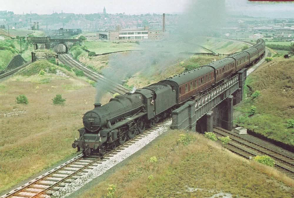 adipullenLNER's tweet photo. Black Five 45372 (8F Wigan Springs Branch) is near Farnley, West Yorkshire with the 12.35pm Leeds-Manchester Exchange working on 30 June 1961. Farnley Junction shed (55C) is just behind the bridge in the background (G Morrison) https://t.co/4iFQhjY7PP