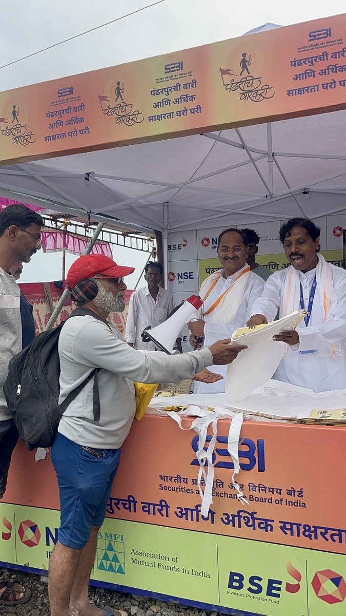 SEBI_India's tweet photo. The joint initiative of SEBI, NSE and BSE along with AMFI  - under the theme “Pandharpurchi wari ani aarthik saksharata gharo ghari” — “Pandharpur pilgrimage and door to door financial literacy” organised stalls at Bhandi Shegaon & Wakhri near Pandharpur on July 22–23, 2026 to educate Warkaris consisting of  farmers, students and senior citizens on safe investing, investor rights, cyber fraud and Ponzi prevention. This financial education initiative was deeply appreciated by one and all.