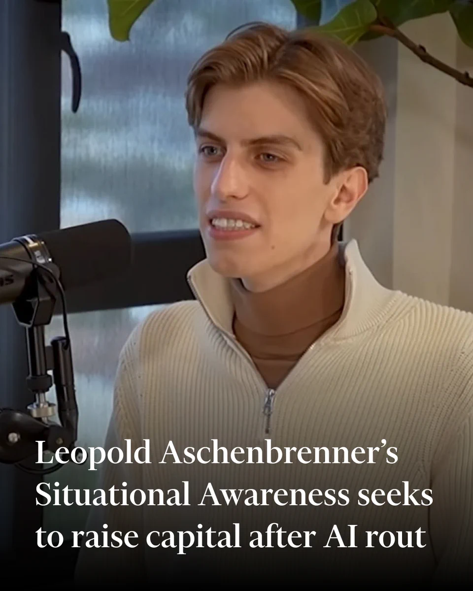Leopold Aschenbrenner speaks into a microphone during a video interview, seated indoors near a window and a leafy plant.