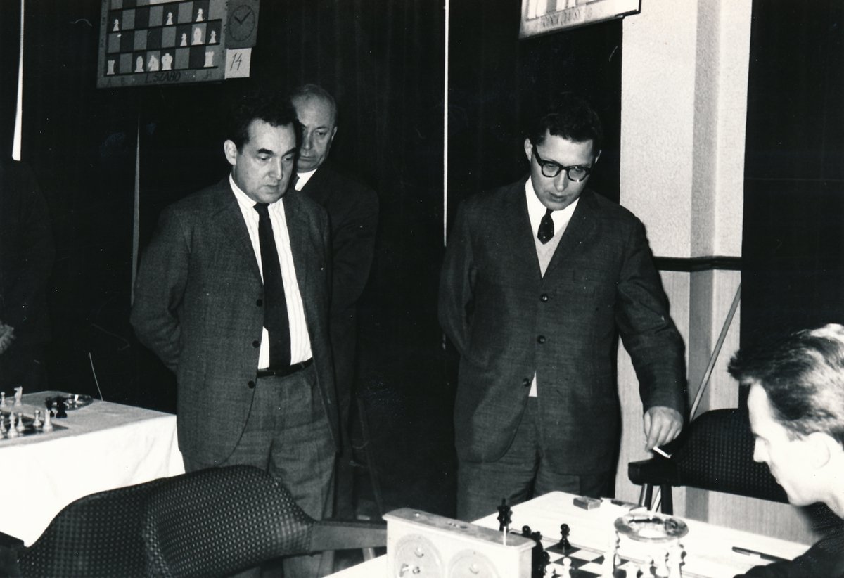 dgriffinchess's tweet photo. Reykjavík, 4th June 1968. In Round 3 of the international tournament taking place in the Icelandic capital, Friðrik Ólafsson is in play v. Evgeny Vasiukov, who stands by the board with a cigarette.
Looking on are Mark Taimanov &amp; László Szabó.
(📷: F. Ólafsson archive.) #chess https://t.co/Sf6NwXIiyG