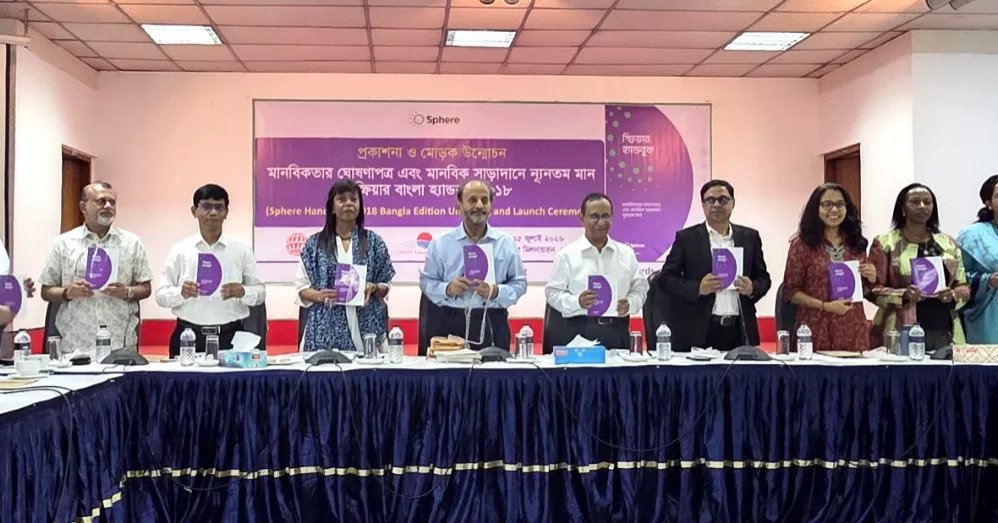 CarolFloreUN's tweet photo. The Bangla edition of the #SphereHandbook is a major step toward stronger, more inclusive &amp; accountable #humanitarianAction in #Bangladesh. By making global standards accessible in Bangla, we empower frontline responders to protect lives, dignity &amp; hope when crises strike. https://t.co/WLQnrc4Dz1