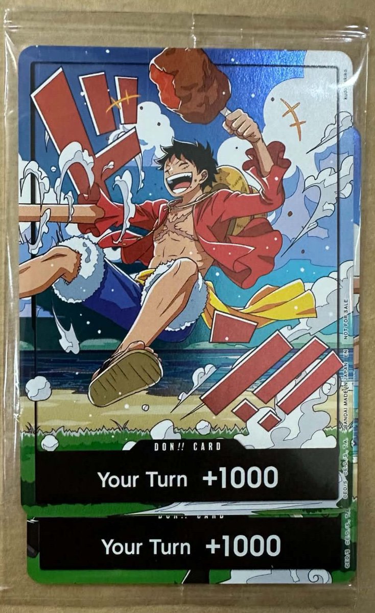OPMerchandise's tweet photo. In person look at the Luffy World United DON!! card with a small peek at Zoro.

Cards will be foiled, but not textured.

You will receive a set of both cards when you participate at the 4th Anniversary Release Event.

#OnePiece
#OnePieceCardGame https://t.co/FG9KsLAMsf