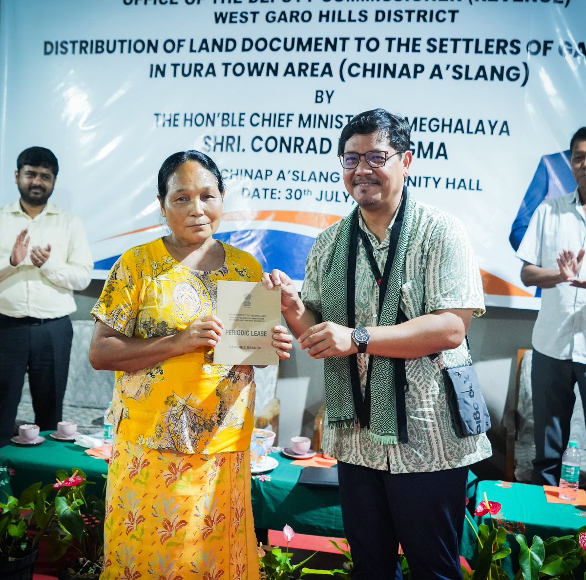 SangmaConrad's tweet photo. Pleased to hand over land pattas to families of Chinap A’slang, marking an important step in resolving the decades-long issue of GAD land occupation in the Tura Town area.

Families who received the document can find security especially in availing loans, necessary certifications, government schemes and services, etc. 

The programme covers 754 households across eight localities in Tura Town. From just 42 households depositing the required premium in December 2025, the number has now grown to 210, with 127 land pattas ready for handover. 

In Chinap A’slang alone out of 93 households, 25 have completed their deposit and have received the documents today.