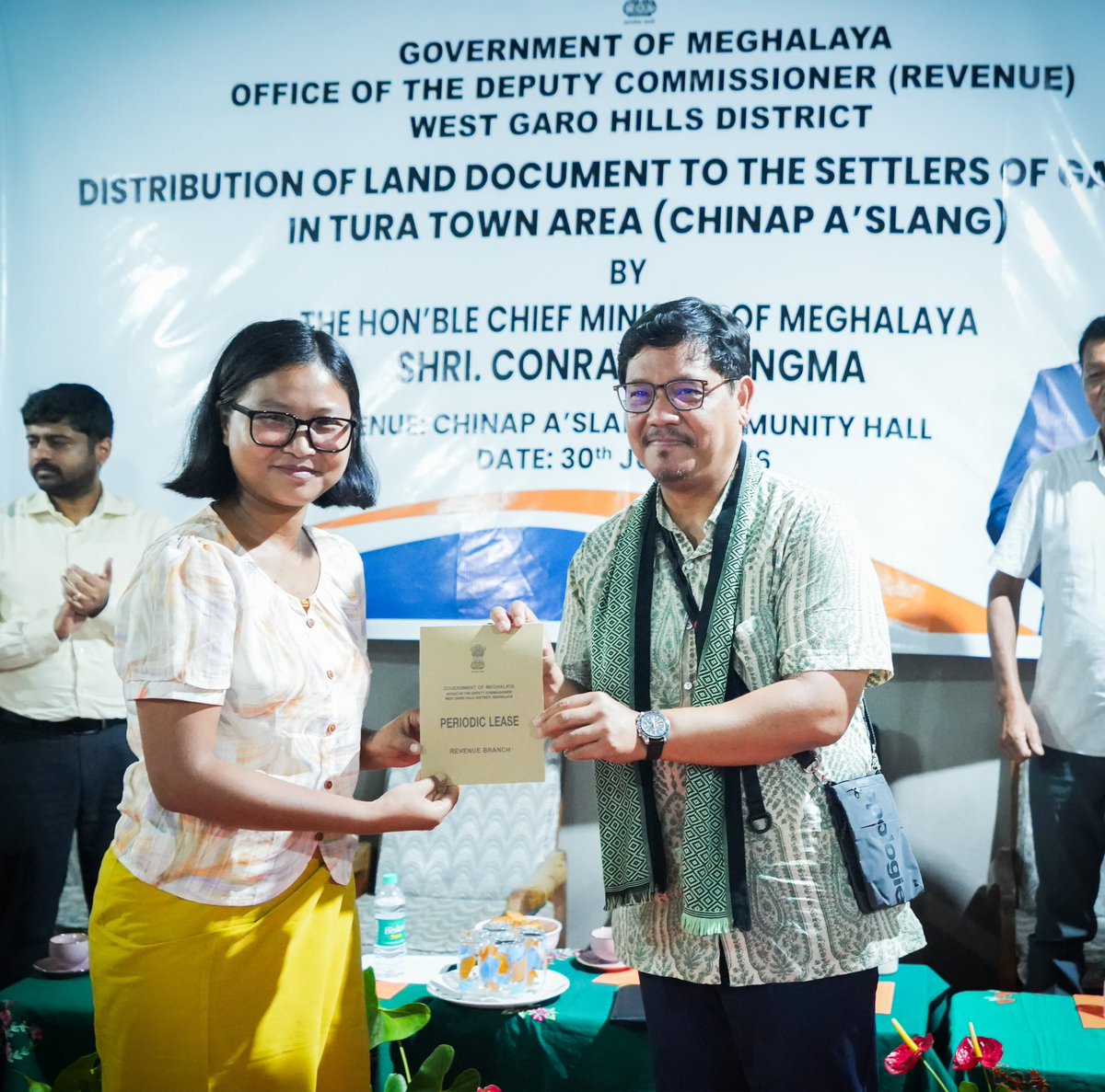 SangmaConrad's tweet photo. Pleased to hand over land pattas to families of Chinap A’slang, marking an important step in resolving the decades-long issue of GAD land occupation in the Tura Town area.

Families who received the document can find security especially in availing loans, necessary certifications, government schemes and services, etc. 

The programme covers 754 households across eight localities in Tura Town. From just 42 households depositing the required premium in December 2025, the number has now grown to 210, with 127 land pattas ready for handover. 

In Chinap A’slang alone out of 93 households, 25 have completed their deposit and have received the documents today.