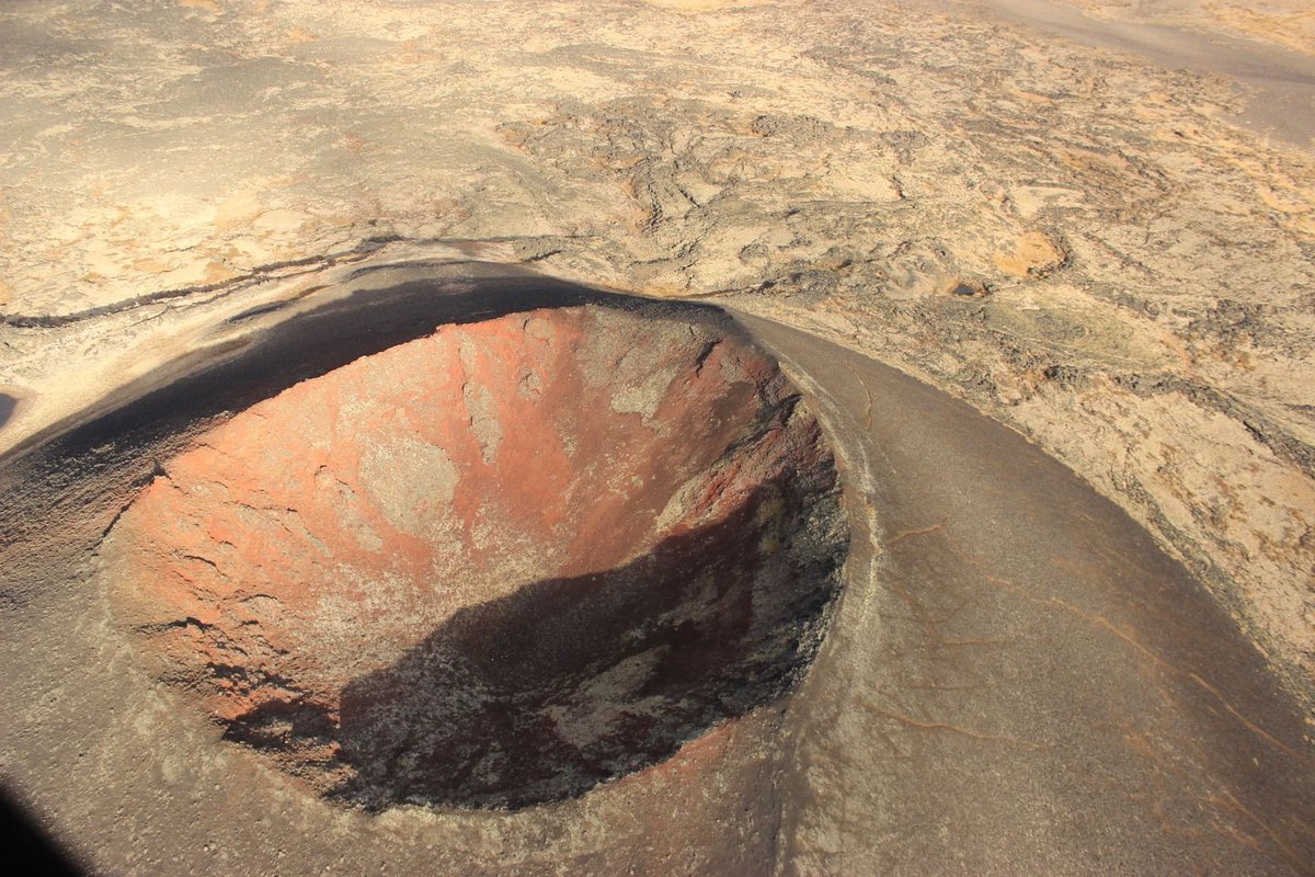 theiaincameron's tweet photo. If you were asked what planet this is, what would you say? Olympus Mons on Mars? The red soil and lack of vegetation would certainly give the impression it's not of this world.

However, it's not on Mars. It's actually in a place you wouldn't expect it to be.

1/3 https://t.co/5KpUDGl8fK