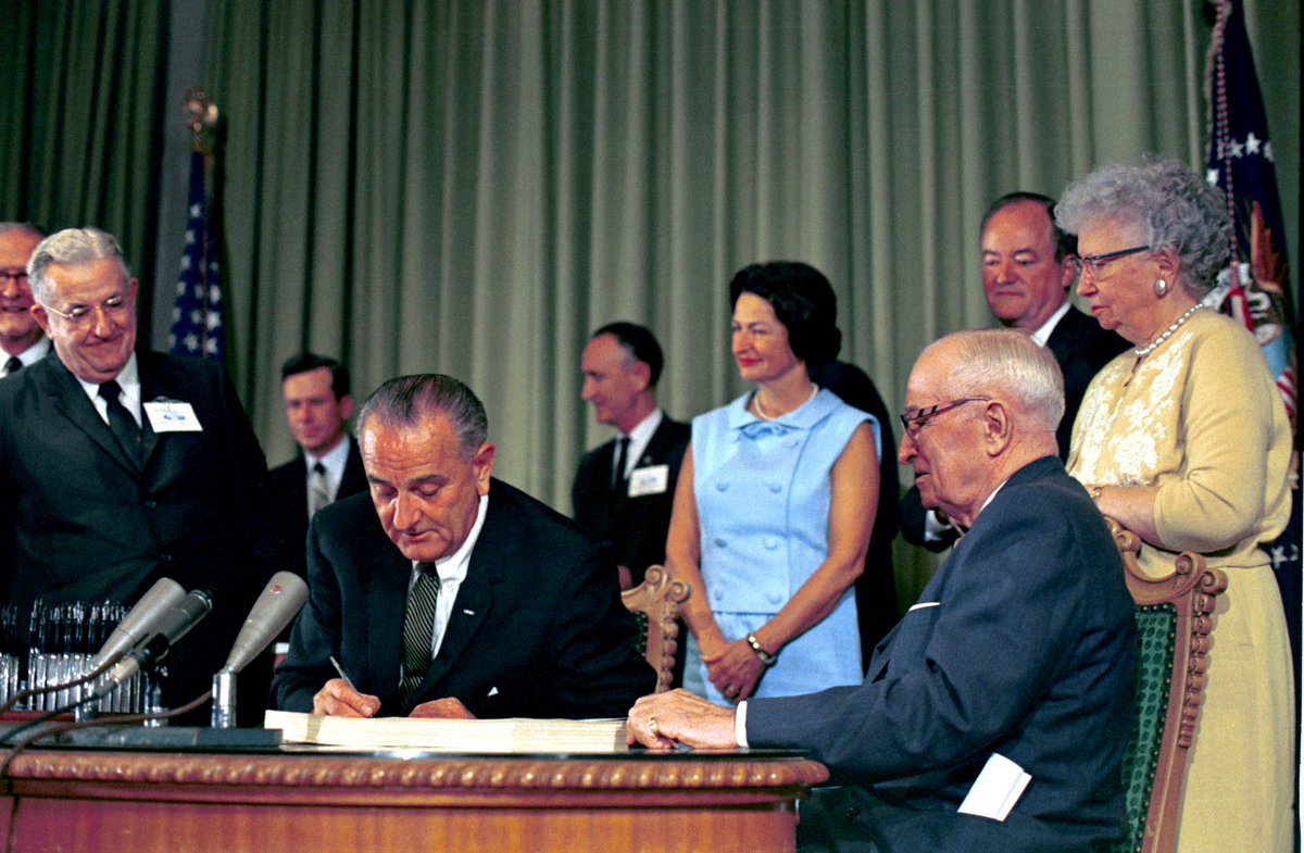 SpeakerPelosi's tweet photo. 61 years ago, President Johnson signed Medicare and Medicaid into law—providing millions of vulnerable Americans with a pillar of health and economic security. 

He did so in Independence, Missouri, alongside President Truman, who championed the initiative during his time in office.
 
As Republicans gut these vital lifelines to give more tax cuts to the rich, our fight to protect the care that millions of Americans rely on has never been more important.