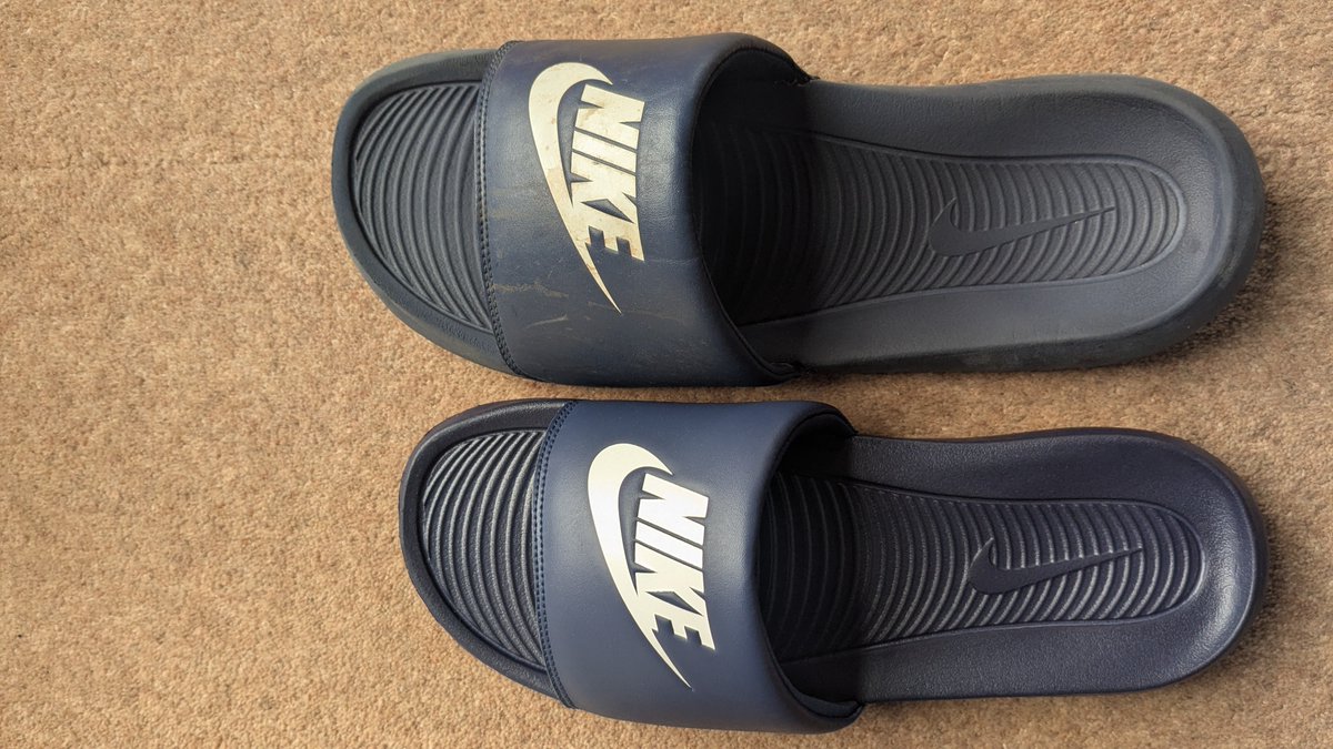 hkselman's tweet photo. @Nike @nikestore @nikelondon 
My son loved his @Nike size 13 (adult) sliders, so asked for some new ones for his birthday. Exactly the same slider and size bought. Not sure what's happened, but they're not going to fit him anytime soon! (The smaller ones are the new ones!) https://t.co/0gzgElYteo