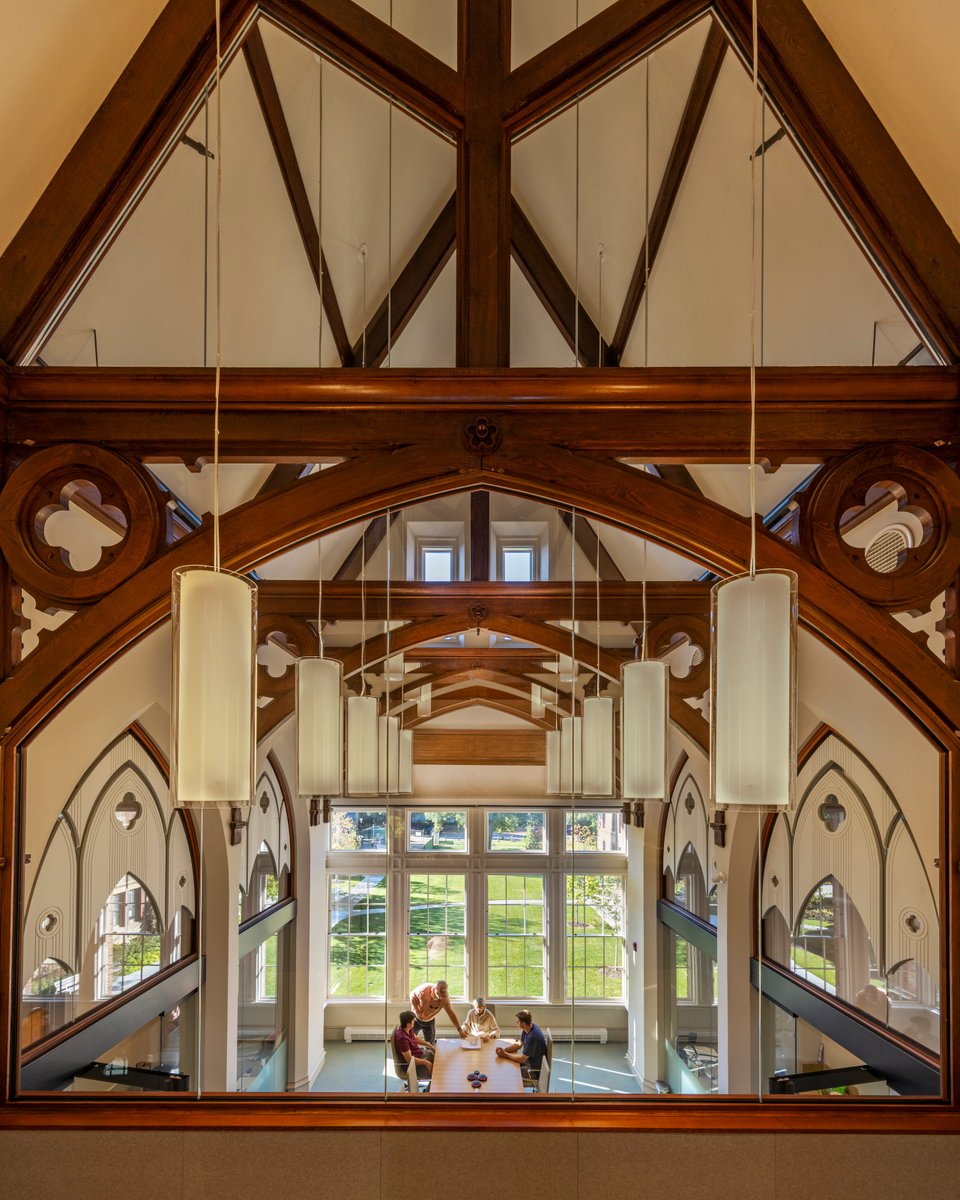 Centerbrook's tweet photo. Interior renovations at @lesley_u removed decades of alterations to reveal original timber trusses, arched openings, and volumetric spaces, restoring a sense of clarity and character. https://t.co/dRdAQwEMoa