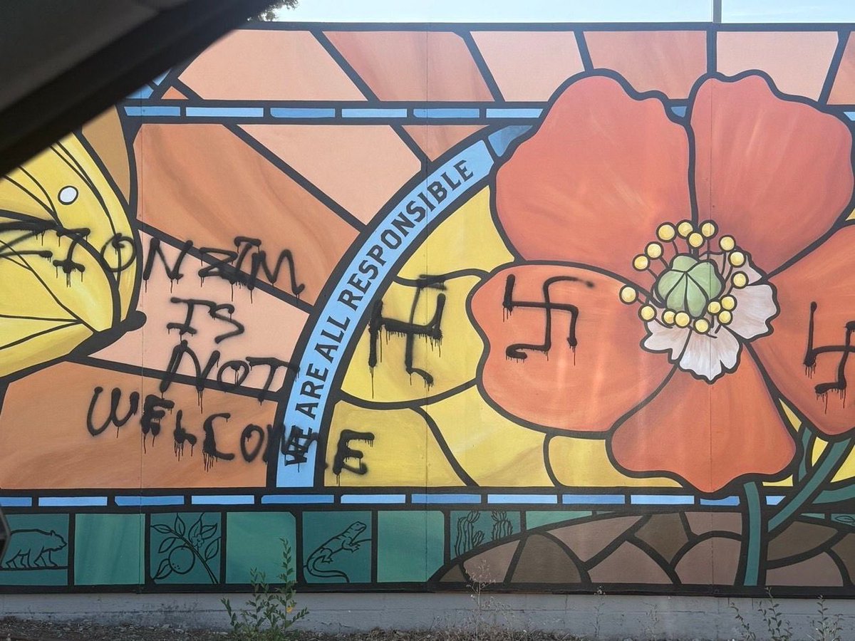 AshagerAraro's tweet photo. Look at this image very carefully.

Spray-painted directly alongside Nazi swastikas on a children’s community mural are the words: "ZIONISM IS NOT WELCOME."

They aren't even trying to hide it anymore.

This is what the anti-Israel movement actually represents: defacing children's art, terrorizing neighborhoods, and adopting the same symbols and hatred as neo-Nazis.

Stop allowing them to hide behind political jargon. Anti-Zionism isn't "justice activism"-it is pure, unadulterated hatred with a spray can.