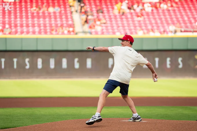 Coach Will Stein throwing baseball. 