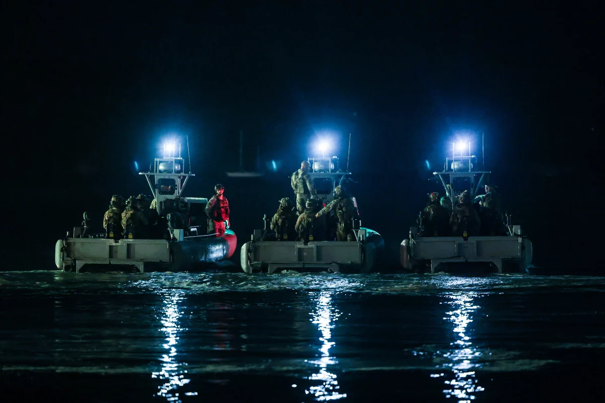 Raiding craft assemble at night ahead of a raiding mission